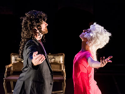 A man and a woman bow to each other on stage.