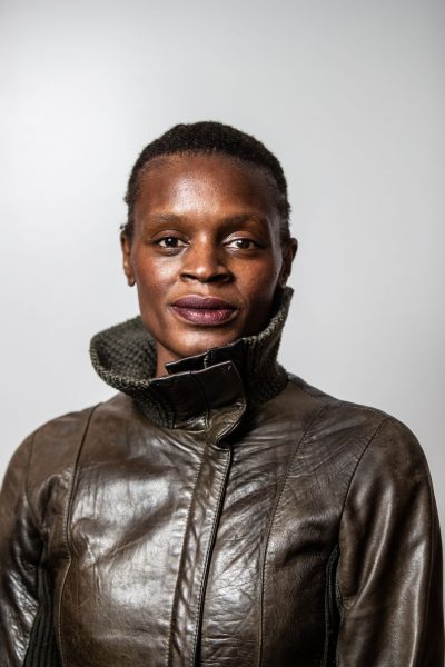 Artist in residence Okwui Okpokwasili poses for a headshot in a leather jacket.