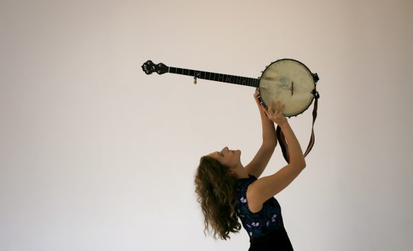 Artist Abigail Washburn holds a banjo above her.